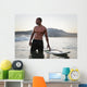 A Man Standing In The Water With His Surfboard Off Valdevaqueros Beach Wall Mural