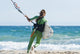 A Woman With Her Kitesurfing Board Walking Into The Water Wall Mural