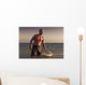 A Man With His Surfboard In The Water At Sunset Wall Mural