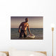 A Man With His Surfboard In The Water At Sunset Wall Mural
