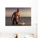 A Man With His Surfboard In The Water At Sunset Wall Mural