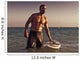 A Man With His Surfboard In The Water At Sunset Wall Mural