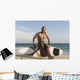 A Man Sits On His Surfboard On The Beach Wall Mural