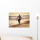 A Man Runs On The Wet Beach At Sunset With His Surfboard Wall Mural