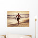 A Man Runs On The Wet Beach At Sunset With His Surfboard Wall Mural
