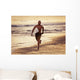 A Man Runs On The Wet Beach At Sunset With His Surfboard Wall Mural