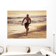 A Man Runs On The Wet Beach At Sunset With His Surfboard Wall Mural