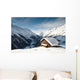 winterscene of alpine valley with snow coverd cabin Wall Mural