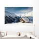 winterscene of alpine valley with snow coverd cabin Wall Mural