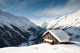 winterscene of alpine valley with snow coverd cabin Wall Mural