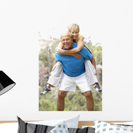Senior Couple Exercising In Park Wall Mural