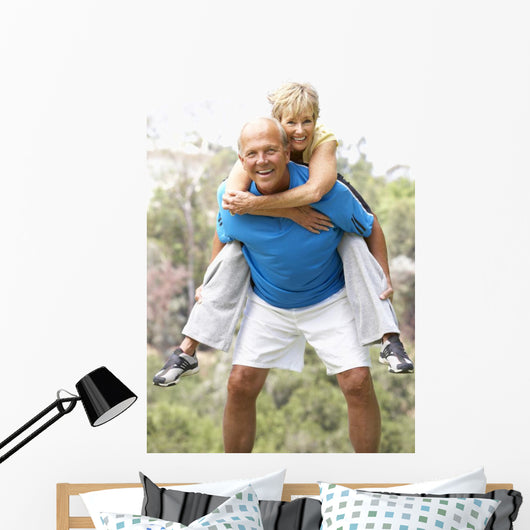Senior Couple Exercising In Park Wall Mural