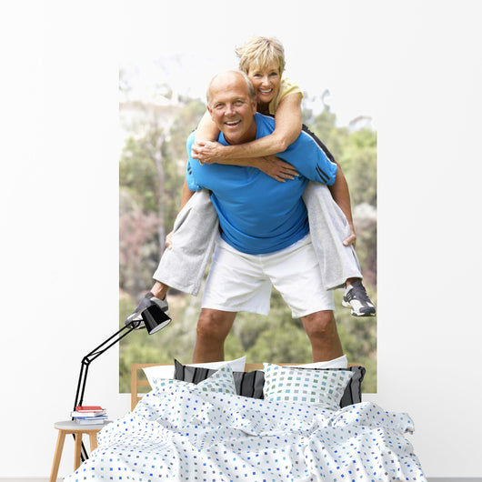 Senior Couple Exercising In Park Wall Mural