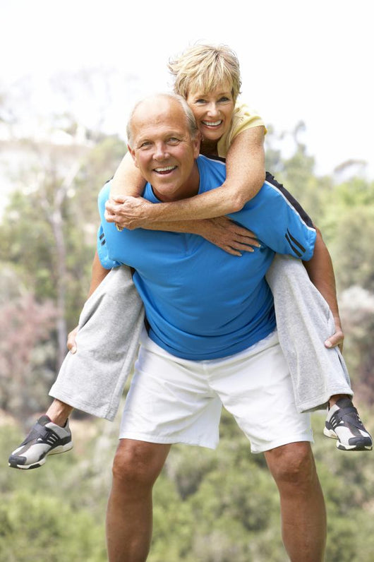 Senior Couple Exercising In Park Wall Mural