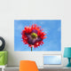 A Colorful Flower With Red And Purple Petals Against A Blue Sky Wall Mural