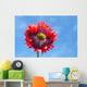 A Colorful Flower With Red And Purple Petals Against A Blue Sky Wall Mural
