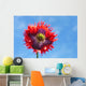 A Colorful Flower With Red And Purple Petals Against A Blue Sky Wall Mural
