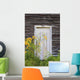 Door To An Old Shed With Wildflowers Growing Outside Wall Mural