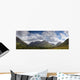 A Mountainous Landscape Under Clouds Wall Mural