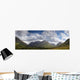 A Mountainous Landscape Under Clouds Wall Mural