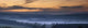 Fog Lies Over A Town At Sunset Wall Mural