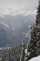 A Red Cable Car Riding Over The Snow Covered Forest Wall Mural