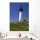 White Lighthouse With A Blue Sky And Wildflowers Wall Mural