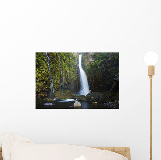 Hawaii, Maui, Nahiku, Woman Standing At Base Of Hanawi Falls Wall Mural