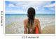 Hawaii, Kauai, Woman Holding Surfboard On Beach, View From Behind Wall Mural