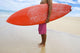 Hawaii, Kauai, Man Holding Surfboard On Beach, View From Side Wall Mural