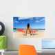Hawaii, Kauai, Woman Sitting On Beach With Surfboard, View From Behind Wall Mural