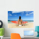 Hawaii, Kauai, Woman Sitting On Beach With Surfboard, View From Behind Wall Mural