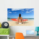 Hawaii, Kauai, Woman Sitting On Beach With Surfboard, View From Behind Wall Mural