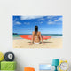 Hawaii, Kauai, Woman Sitting On Beach With Surfboard, View From Behind Wall Mural