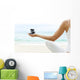 Hawaii, Woman Holding Stack Of Stones In Hands, Ocean In Background Wall Mural