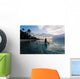 Woman Paddling In Outrigger Canoe Along Shoreline Wall Mural