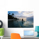 Woman Paddling In Outrigger Canoe Along Shoreline Wall Mural