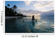 Woman Paddling In Outrigger Canoe Along Shoreline Wall Mural