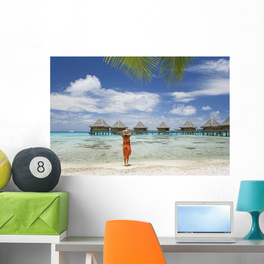 Woman On Beach Near Luxury Resort Wall Mural
