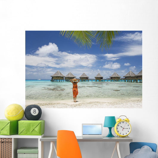 Woman On Beach Near Luxury Resort Wall Mural