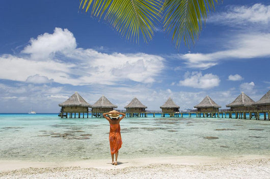 Woman On Beach Near Luxury Resort Wall Mural