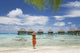 Woman On Beach Near Luxury Resort Wall Mural