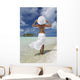 Woman In White Standing At Ocean's Edge Wall Mural