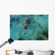 School Of Fish Encircling Woman Floating In Tropical Ocean Water Wall Mural