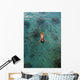 School Of Fish Encircling Woman Floating In Tropical Ocean Water Wall Mural