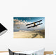 Two vintage WWI double wing biplanes flying over canyon Wall Mural