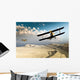 Two vintage WWI double wing biplanes flying over canyon Wall Mural