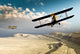 Two vintage WWI double wing biplanes flying over canyon Wall Mural