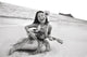 Young Girl Smiling And Playing Ukulele On The Beach In A Hula Skirt Wall Mural
