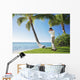 Ready To Swing His Golf Club At A Beach Front Golf Course Wall Mural